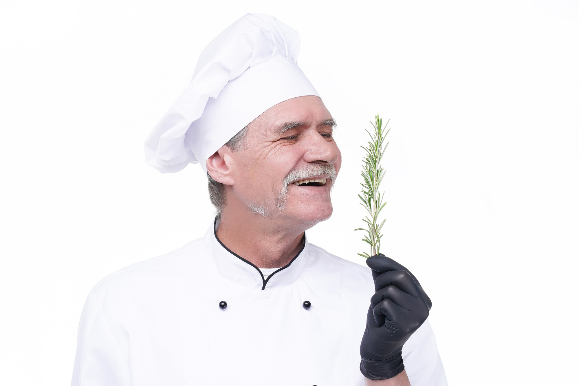 Chef mentor smiling with herbs